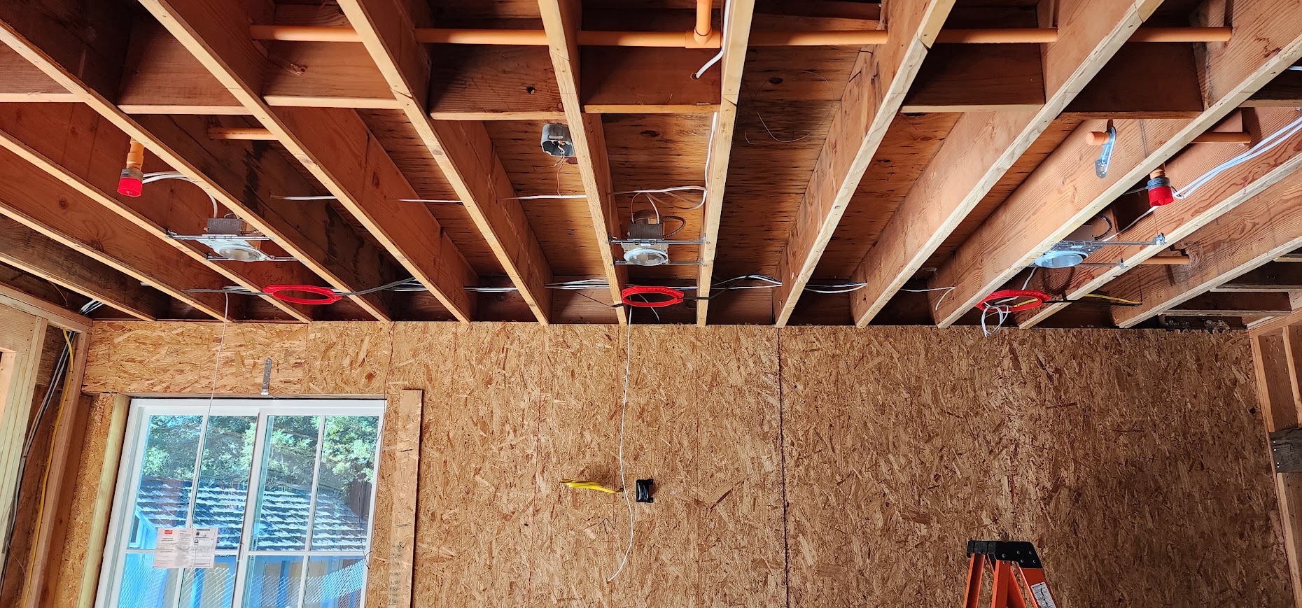 Cable routes through open ceiling framing